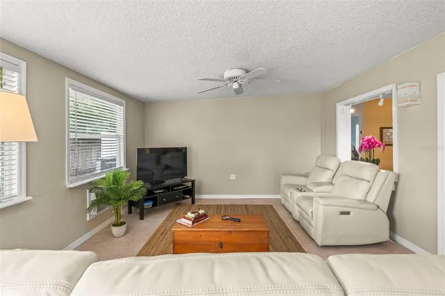 a living room with furniture and a dining table