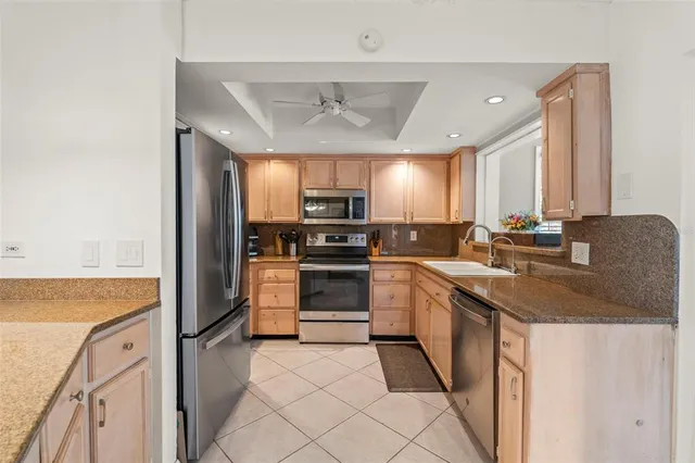 a kitchen with a sink stove and microwave