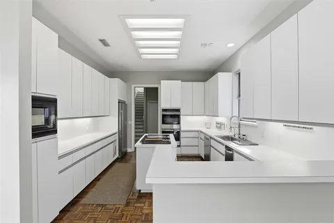 a kitchen that has a sink and a stove in it