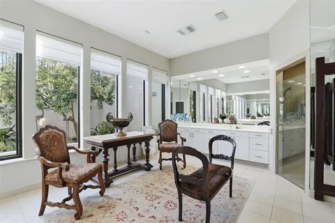 a room with furniture a large window and wooden floor