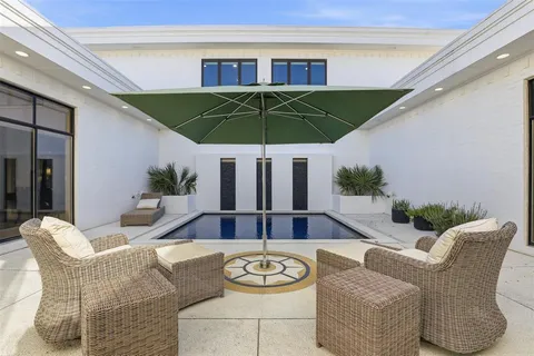 a view of a patio with furniture and potted plants