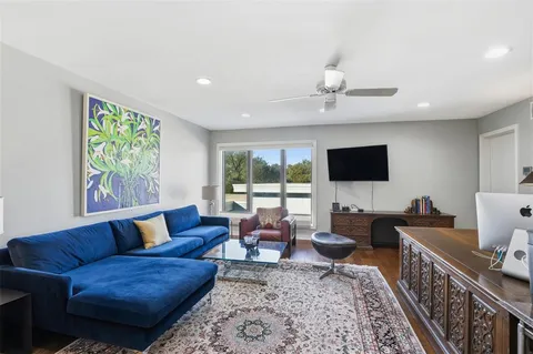 a living room with furniture and a book shelf