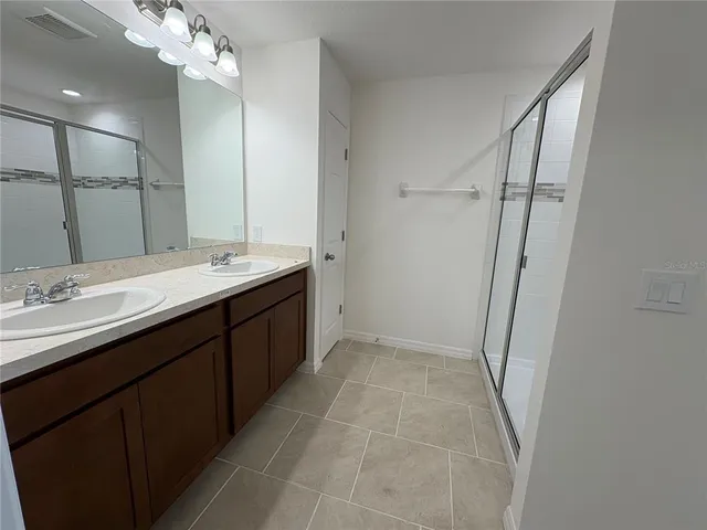 a bathroom with a double vanity sink a and mirror