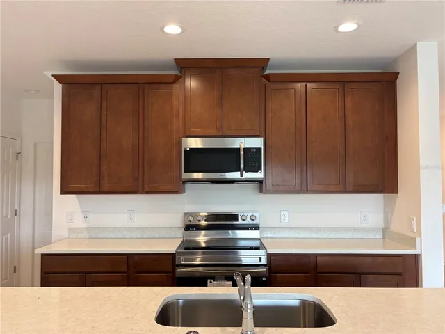 a kitchen with a sink and a microwave