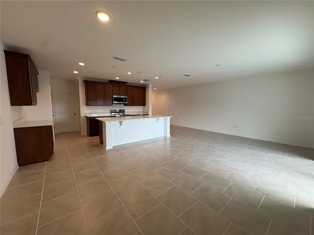 a view of kitchen with microwave and cabinets