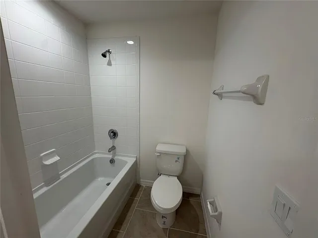 a bathroom with a toilet and a bathtub