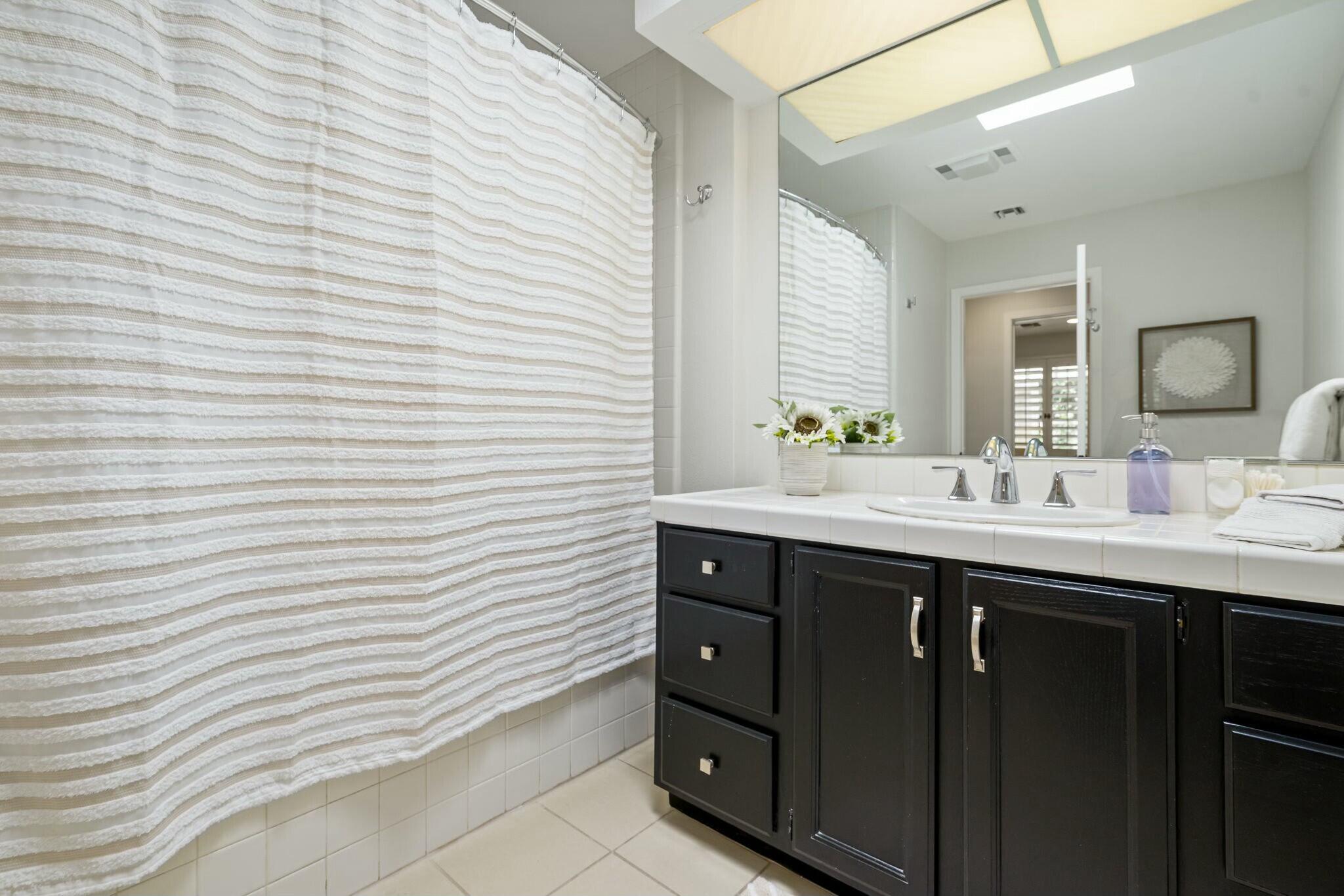 38 Mission Court Rancho Mirage, CA 92270 - Photo 56 of 61 a bathroom with a sink and a mirror