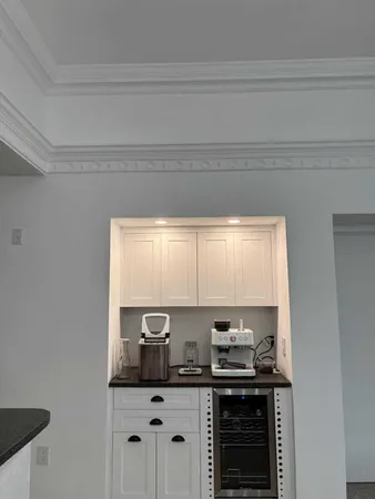 a kitchen with granite countertop a sink cabinets window and stainless steel appliances