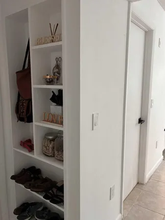 a room with a wooden floor and shoes