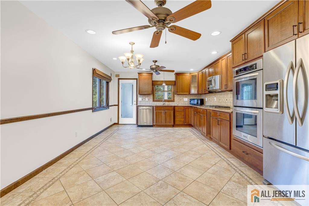 5 Montview Road Edison, NJ 08837 - Photo 11 of 47 a large kitchen with cabinets and stainless steel appliances