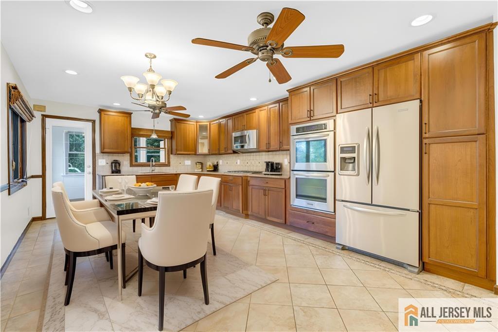 5 Montview Road Edison, NJ 08837 - Photo 13 of 47 a kitchen with stainless steel appliances granite countertop a refrigerator a sink dishwasher and a stove with a dining table
