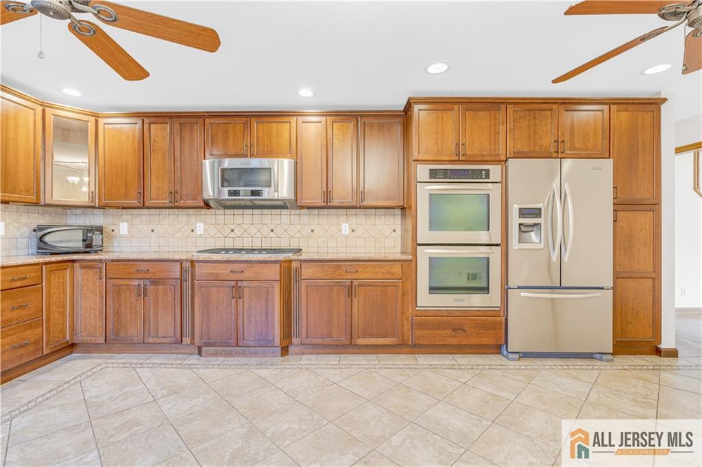 5 Montview Road Edison, NJ 08837 - Photo 14 of 47 a kitchen with stainless steel appliances granite countertop a stove a sink and a refrigerator