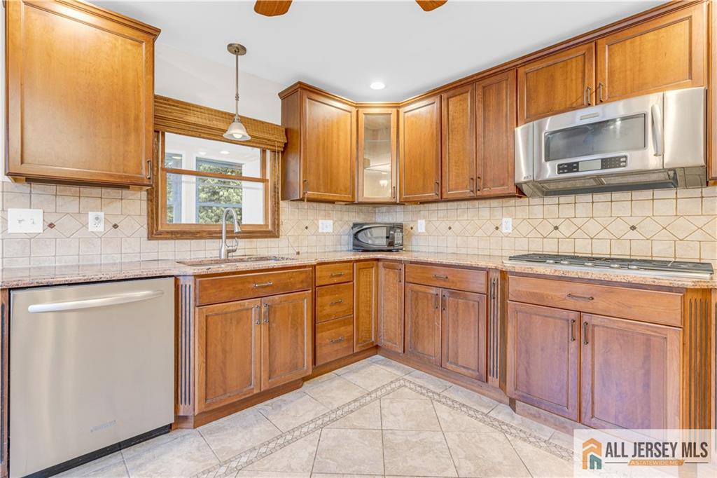5 Montview Road Edison, NJ 08837 - Photo 15 of 47 a kitchen with stainless steel appliances granite countertop a sink stove and cabinets