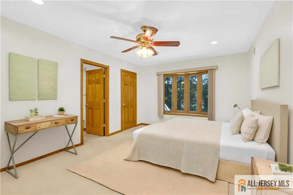 5 Montview Road Edison, NJ 08837 - Photo 21 of 47 a bedroom with a bed and a chandelier