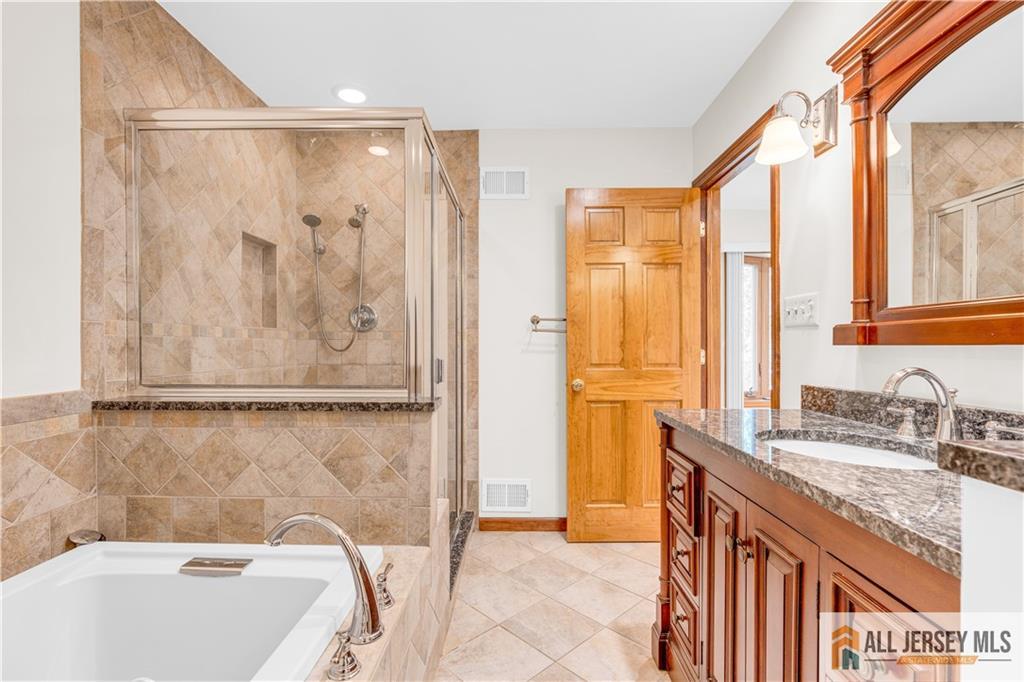 5 Montview Road Edison, NJ 08837 - Photo 25 of 47 a bathroom with a granite countertop sink a mirror and a bathtub