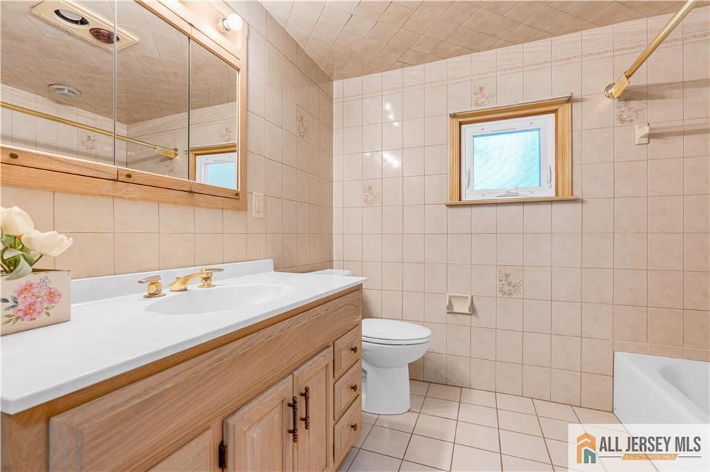 5 Montview Road Edison, NJ 08837 - Photo 32 of 47 a bathroom with a sink a toilet and a mirror