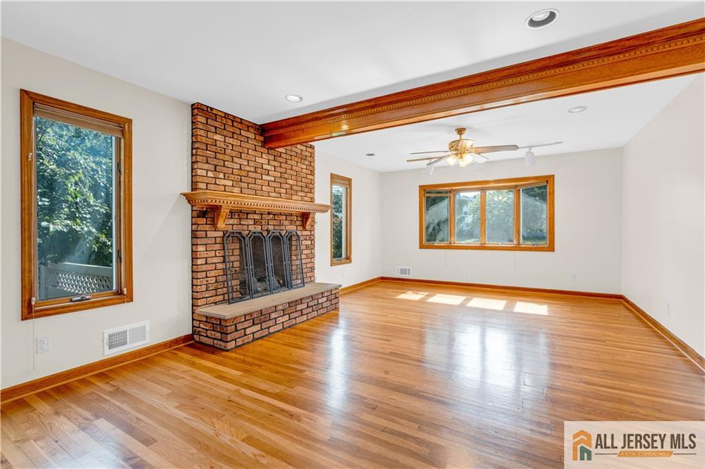 5 Montview Road Edison, NJ 08837 - Photo 7 of 47 a view of an empty room with window and wooden floor