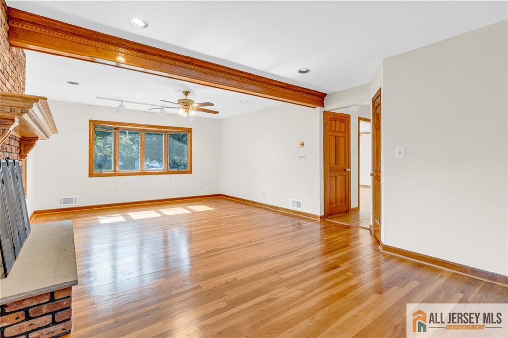 5 Montview Road Edison, NJ 08837 - Photo 9 of 47 a view of an empty room with wooden floor and a window