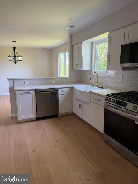 12 Wren Road Gilbertsville, PA 19525 - Photo 8 of 17 a kitchen with stainless steel appliances granite countertop a stove a sink and a microwave