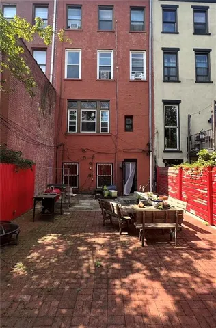 a view of a brick building with many windows
