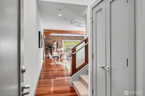 a kitchen with stainless steel appliances granite countertop a refrigerator a sink dishwasher a stove with wooden floor and cabinets