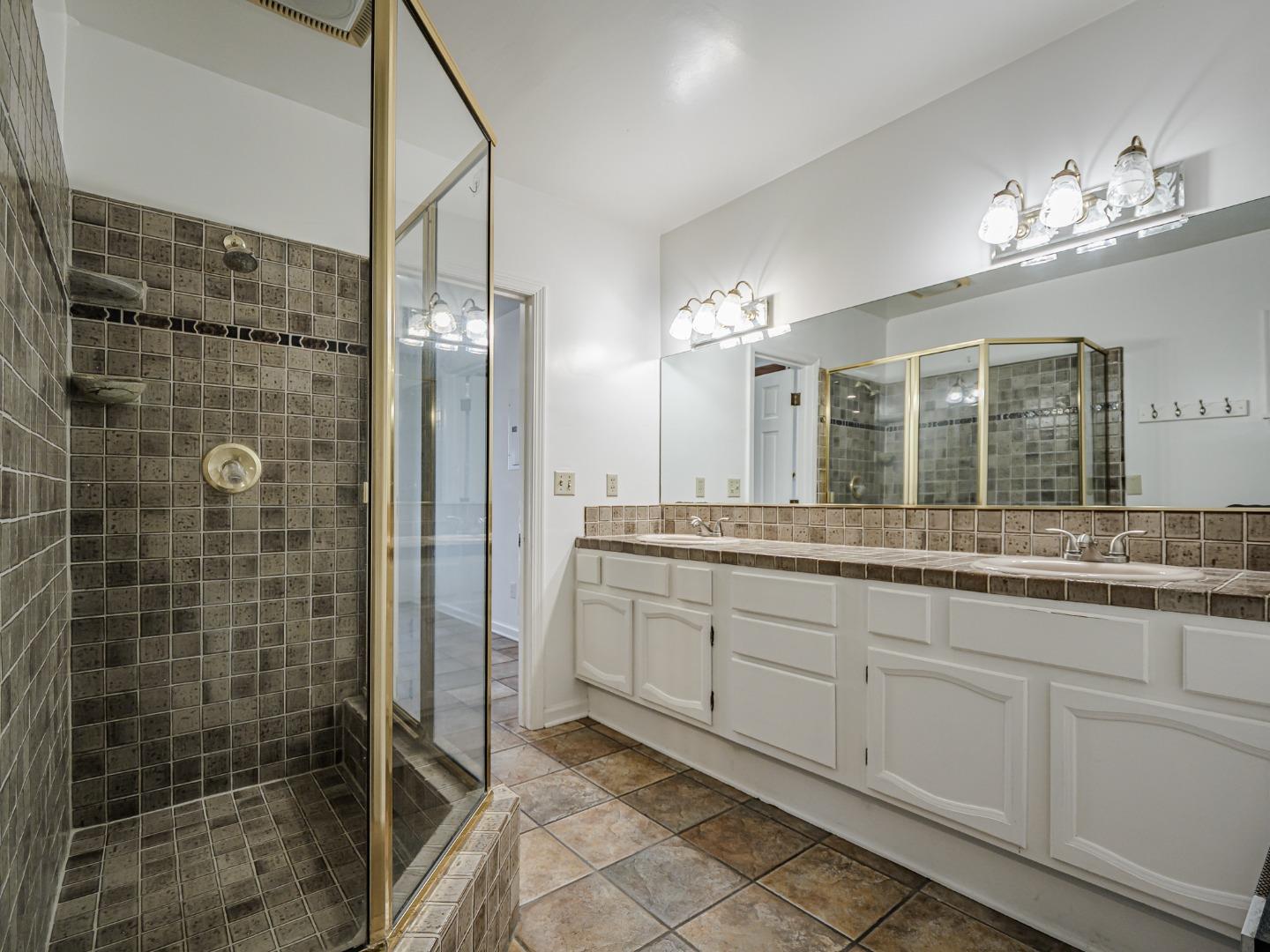 1459 High Street Santa Cruz, CA 95060 - Photo 25 of 62 a bathroom with a granite countertop sink a mirror and shower