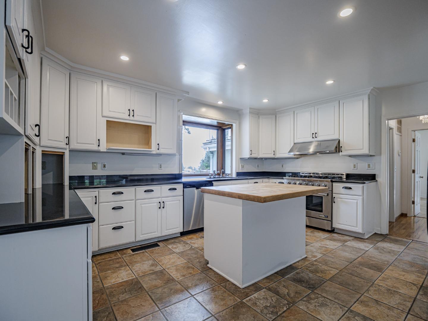 1459 High Street Santa Cruz, CA 95060 - Photo 3 of 62 a kitchen with stainless steel appliances granite countertop a stove top oven a sink a refrigerator and white cabinets