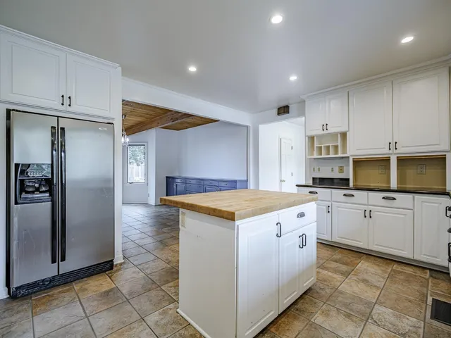 a kitchen with granite countertop a stove oven and refrigerator