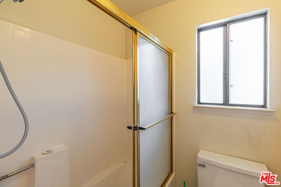 1217 Ave H4 Lancaster, CA 93534 - Photo 12 of 18 a bathroom with a toilet and a shower