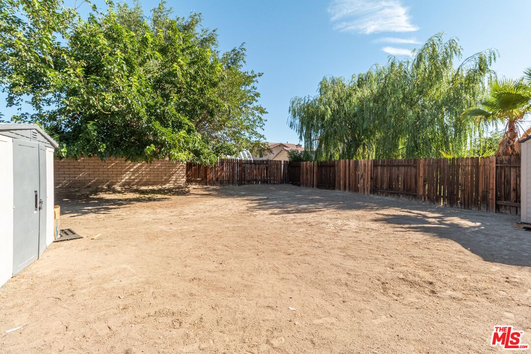 1217 Ave H4 Lancaster, CA 93534 - Photo 17 of 18 a swimming pool with outdoor seating and yard