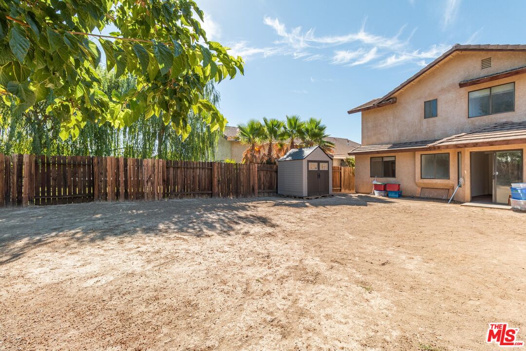 1217 Ave H4 Lancaster, CA 93534 - Photo 18 of 18 a front view of a house with a yard