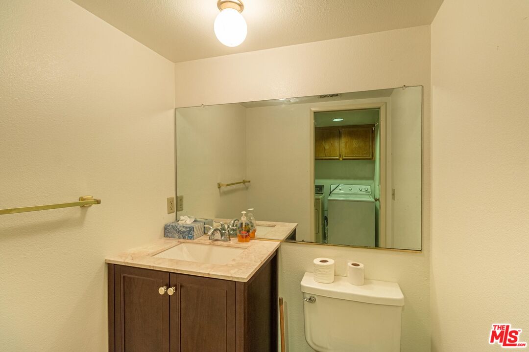 1217 Ave H4 Lancaster, CA 93534 - Photo 6 of 18 a bathroom with a sink and a mirror