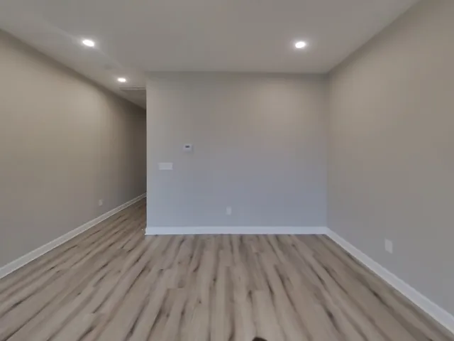 a view of room with wooden floor