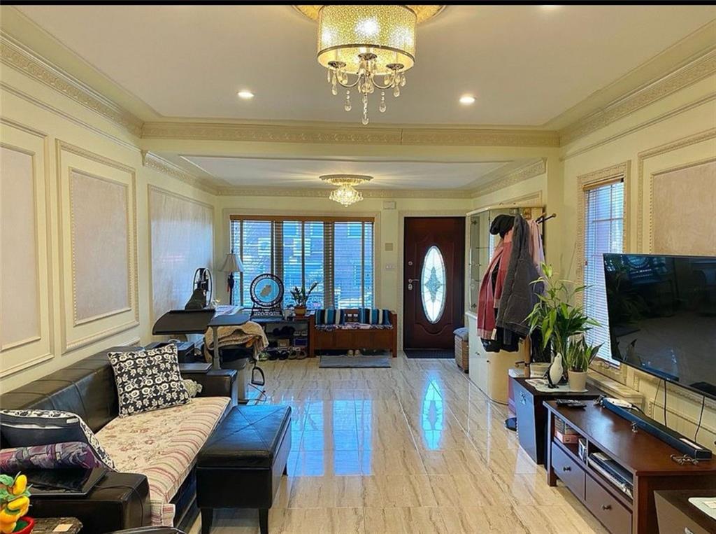 1727 East 16th Street Brooklyn, NY 11229 - Photo 12 of 35 a living room with furniture and a flat screen tv