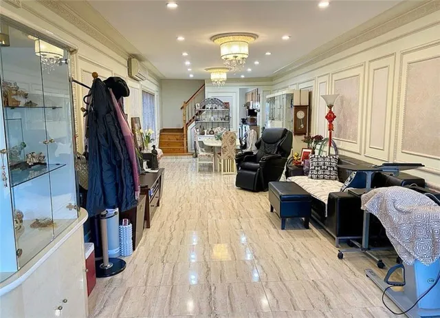 a kitchen with stainless steel appliances granite countertop a stove a sink dishwasher and white cabinets with wooden floor