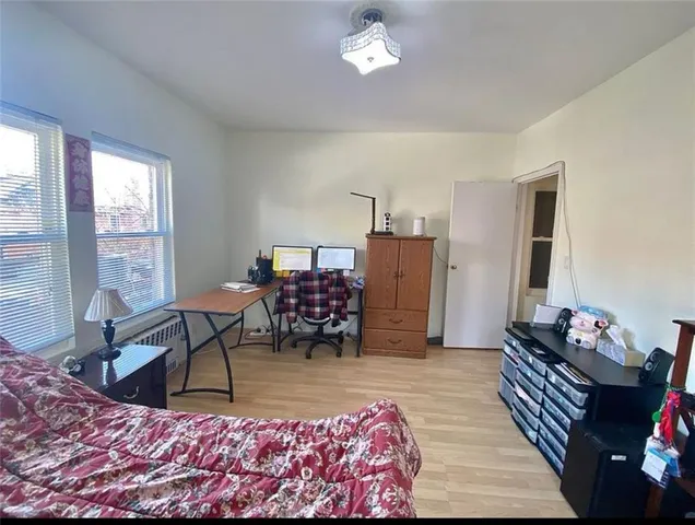 a bedroom with a bed and large windows