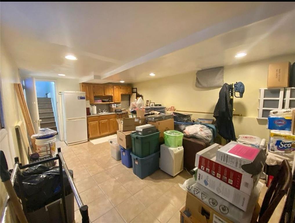 1727 East 16th Street Brooklyn, NY 11229 - Photo 32 of 35 a kitchen with a sink appliances and cabinets
