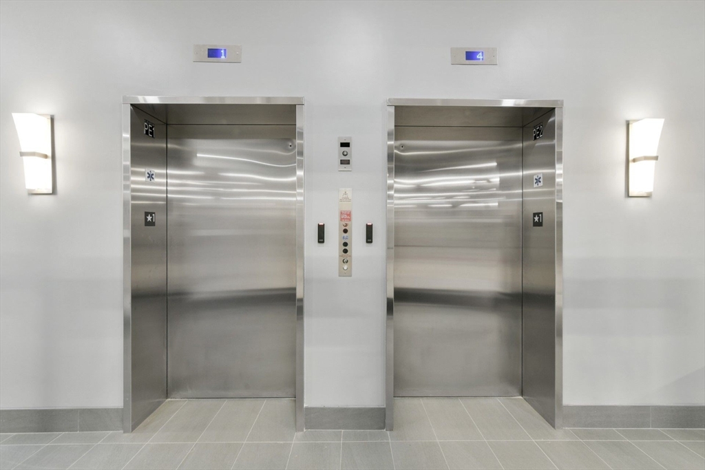 585 Essex Street, Unit 519 Lynn, MA 01901 - Photo 16 of 19 a kitchen with white cabinets and refrigerator