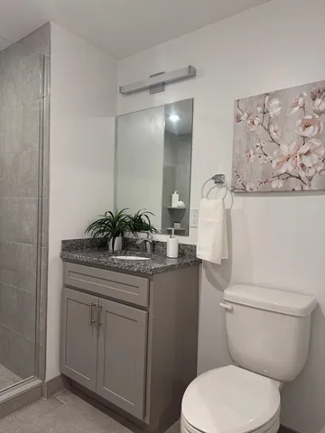 a bathroom with a shower and a sink