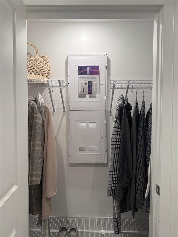585 Essex Street, Unit 519 Lynn, MA 01901 - Photo 7 of 19 a view of walk in closet with clothes and shoes
