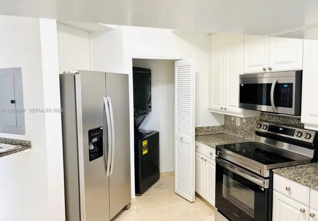 a kitchen with stainless steel appliances a stove a microwave and a refrigerator