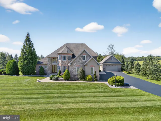 a front view of a house with a garden and yard