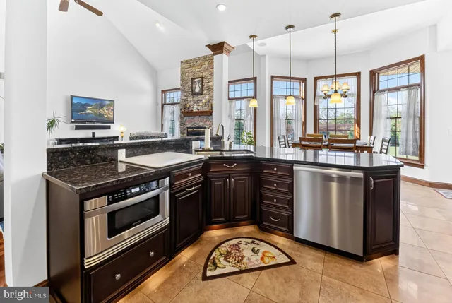 a view of a dining room with furniture large window and chandelier