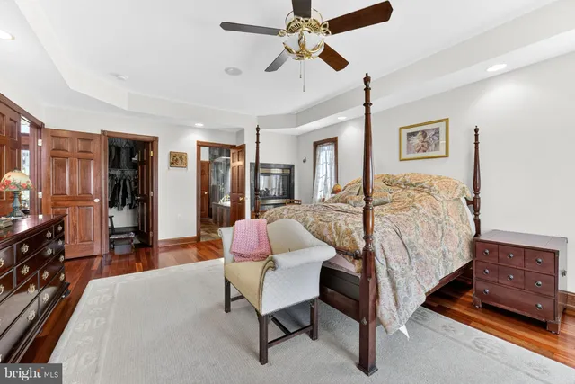 a spacious bathroom with a granite countertop tub sink a mirror and a shower