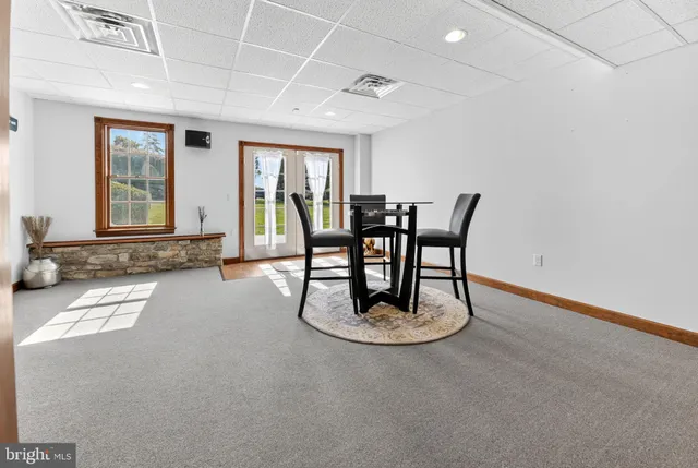 a front view of a house with a yard and potted plants