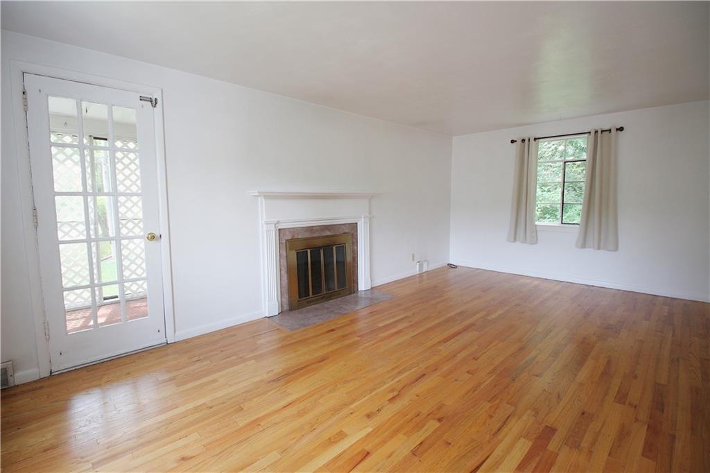 515 Filmore Road Pittsburgh, PA 15221 - Photo 3 of 14 a view of empty room with wooden floor and fan