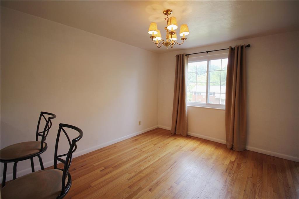 515 Filmore Road Pittsburgh, PA 15221 - Photo 6 of 14 a view of a room with wooden floor chandelier and windows