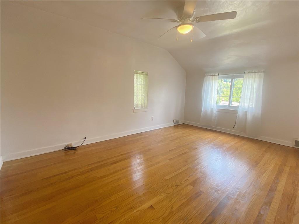 515 Filmore Road Pittsburgh, PA 15221 - Photo 9 of 14 an empty room with wooden floor and windows