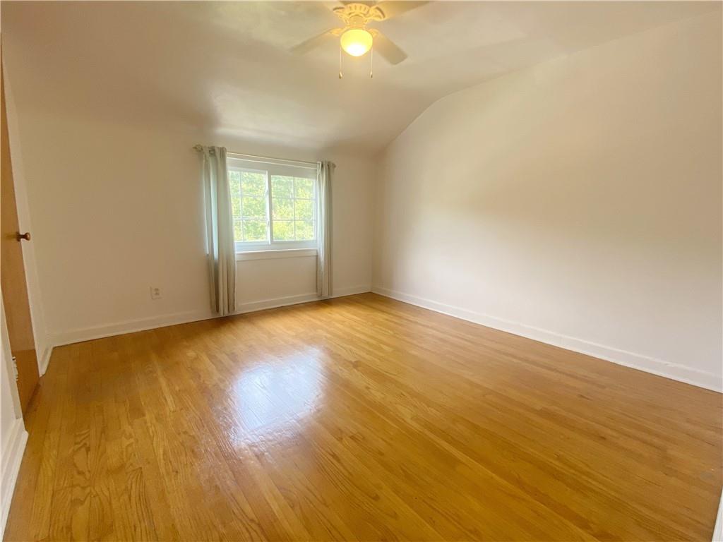 515 Filmore Road Pittsburgh, PA 15221 - Photo 10 of 14 a view of an empty room with wooden floor and a window