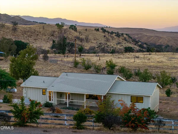 a aerial view of a house next to a yard